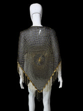 Load image into Gallery viewer, A black mesh poncho-style shawl with intricate gold beadwork and fringe, displayed on a white mannequin from the back.
