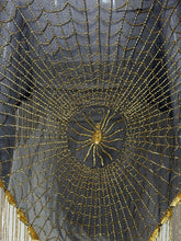 Load image into Gallery viewer, A circular black mesh or tulle fabric backdrop decorated with a radial pattern of gold sequins and beads, featuring a central spider motif and a scalloped fringe along the lower edge.
