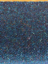 Load image into Gallery viewer, A close-up of a dense fabric or material surface covered in small iridescent rhinestones that shift between blue, teal, purple, and pink.
