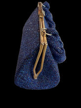 Load image into Gallery viewer, A dark blue beaded clutch handbag with a gold-tone metal frame and a knotted braided shoulder strap.
