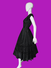 Load image into Gallery viewer, A black sleeveless fit-and-flare dress with cap sleeves, a scoop neckline, and ornate lace and bead trim details, displayed on a white mannequin.
