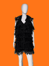 Load image into Gallery viewer, Black ruffled tulle dress shown on a white mannequin featuring a tiered ruffle skirt and a sheer ruffled collar.

