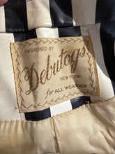 Load image into Gallery viewer, Close-up of a vintage striped garment label reading 'FASHIONED BY Debutogs NEW YORK for ALL WEATHER' sewn onto black-and-white striped fabric.
