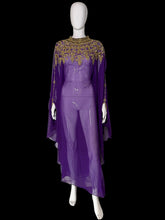 Load image into Gallery viewer, A purple sheer maxi dress with a high embroidered neckline and long draped sleeves, displayed on a white mannequin.
