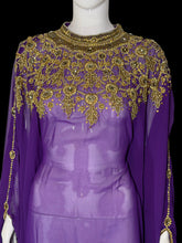 Load image into Gallery viewer, A purple sheer dress displayed on a mannequin, featuring extensive gold beaded and sequined floral embroidery across the yoke and shoulders, with matching gold beadwork along the sheer sleeves.
