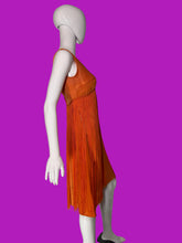 Load image into Gallery viewer, An orange sleeveless fringe dress displayed on a white mannequin in a side profile view.
