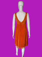 Load image into Gallery viewer, An orange sleeveless fringe dress displayed on a white mannequin, shown from the back.
