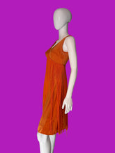 Load image into Gallery viewer, An orange sleeveless fringe dress displayed on a white mannequin, shown from the side. 
