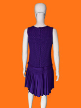 Load image into Gallery viewer, A purple sleeveless dress with a textured bodice and pleated skirt, displayed on a white mannequin.
