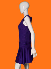 Load image into Gallery viewer, A purple sleeveless dress with a textured bodice and pleated skirt, displayed on a white mannequin.
