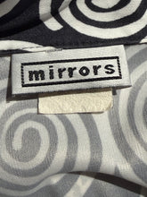 Load image into Gallery viewer, Close-up of a fabric garment with a black and gray spiral pattern, featuring a sewn-in label that reads 'mirrors'.
