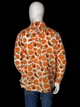 Load image into Gallery viewer, A long-sleeve button-up shirt with an all-over orange jack-o'-lantern pattern on a white background, displayed on a white mannequin torso shown from the back.
