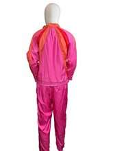 Load image into Gallery viewer, Mannequin wearing a bright pink and orange tracksuit 
