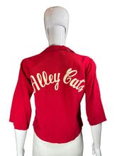 Load image into Gallery viewer, Red shorts with white text on a mannequin against a plain background
