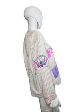 Load image into Gallery viewer, Mannequin wearing a patterned shirt against a plain wall.
