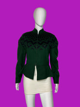 Load image into Gallery viewer, A dark green knit jacket with a black geometric pattern across the yoke and shoulders, displayed on a white mannequin.
