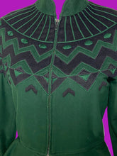 Load image into Gallery viewer, A close up of a dark green knit jacket with a black geometric pattern across the yoke and shoulders, displayed on a white mannequin.
