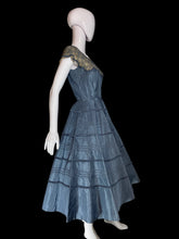 Load image into Gallery viewer, A blue tiered taffeta dress with a lace shoulder detail, displayed on a white mannequin.
