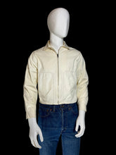 Load image into Gallery viewer, A cream-colored zip-up jacket displayed on a white mannequin torso.
