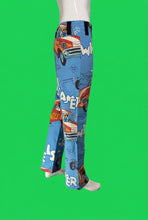 Load image into Gallery viewer, Blue flared pants with a retro comic-book car print, displayed on a mannequin.
