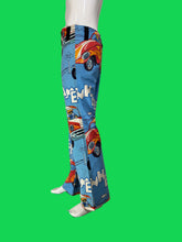 Load image into Gallery viewer, A pair of blue wide-leg pants with a retro  car print, displayed on a mannequin 
