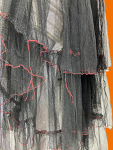 Load image into Gallery viewer, Multi-layered mesh sheer skirt with red threaded hems on each layer. 
