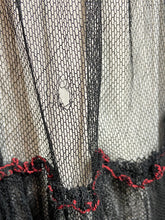 Load image into Gallery viewer, A small tear shown in one layer of the sheer mesh skirt.
