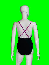 Load image into Gallery viewer, A black one-piece swimsuit shown from the back on a white mannequin, featuring magenta-pink crisscross shoulder straps.
