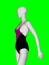 Load image into Gallery viewer, A white mannequin torso wearing a one-piece swimsuit with a bright magenta-pink front and a solid black back.
