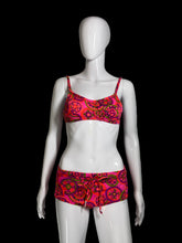 Load image into Gallery viewer, A two-piece bikini swimsuit with a vibrant pink, red, and green paisley pattern, displayed on a white mannequin.
