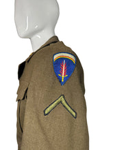 Load image into Gallery viewer,  military jacket with embroidered shoulder patches on a white background
