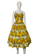 Load image into Gallery viewer, Mannequin wearing a floral dress with yellow flowers on a plain background
