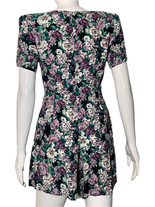 Floral patterned romper on a mannequin against a white background