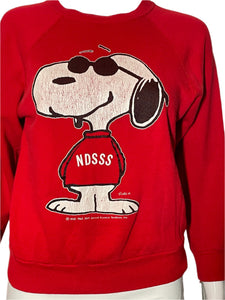 Red sweatshirt with a cartoon dog design and 'NDSSS' text on a white background
