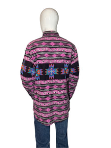 Mannequin wearing a colorful patterned garment on a plain background
