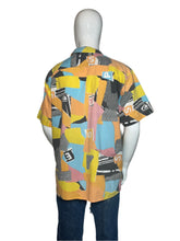 Load image into Gallery viewer, Mannequin wearing a colorful patterned garment on a plain background
