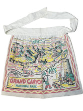 Load image into Gallery viewer, novelty apron with Grand Canyon National Park design on a gray surface
